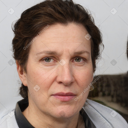 Joyful white adult female with short  brown hair and grey eyes