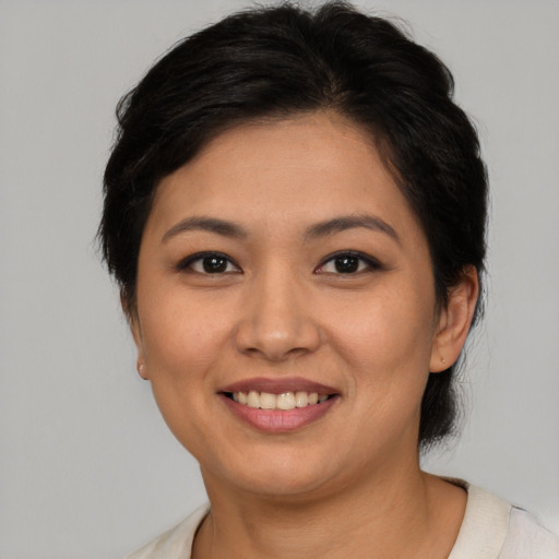 Joyful asian young-adult female with medium  brown hair and brown eyes