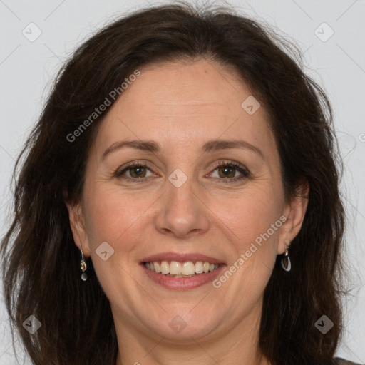 Joyful white adult female with long  brown hair and brown eyes