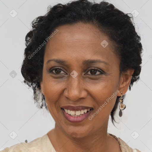 Joyful black adult female with short  brown hair and brown eyes