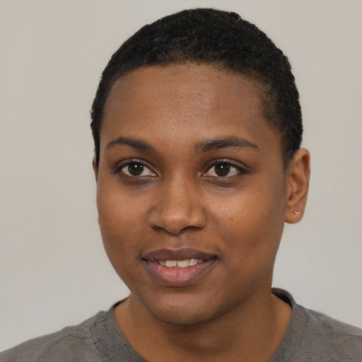 Joyful black young-adult female with short  black hair and brown eyes