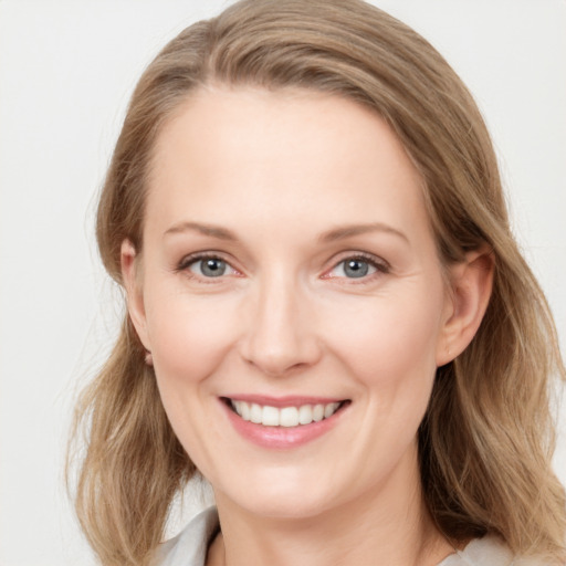 Joyful white young-adult female with medium  brown hair and blue eyes