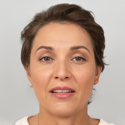 Joyful white adult female with short  brown hair and brown eyes