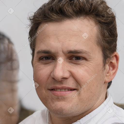 Joyful white adult male with short  brown hair and brown eyes