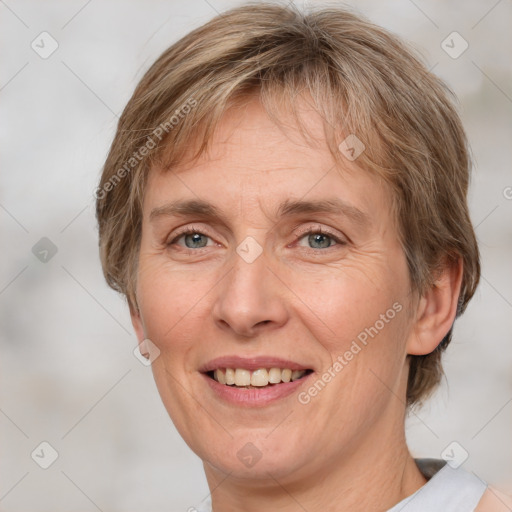 Joyful white adult female with medium  brown hair and grey eyes