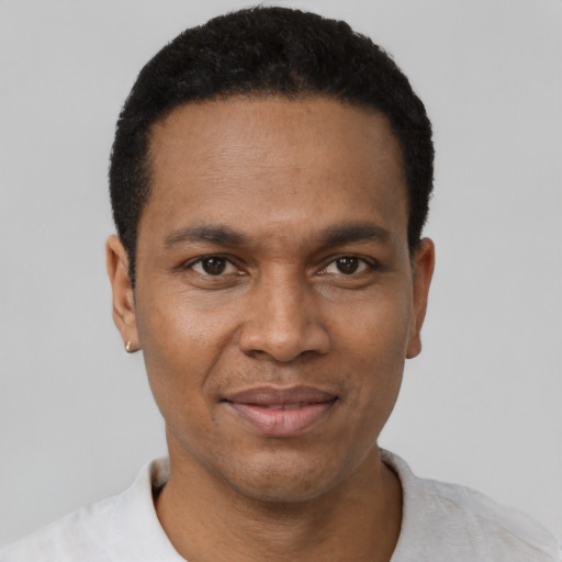 Joyful black young-adult male with short  black hair and brown eyes