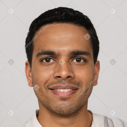 Joyful latino young-adult male with short  black hair and brown eyes