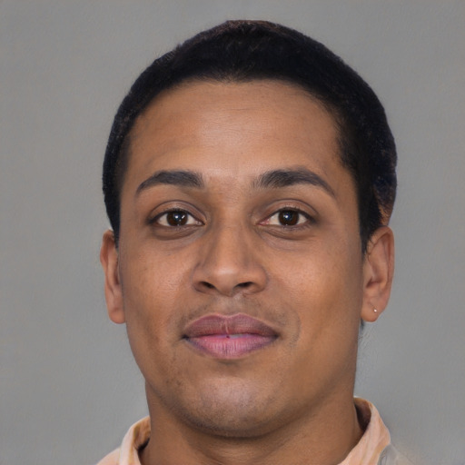 Joyful latino young-adult male with short  brown hair and brown eyes