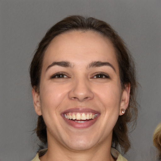 Joyful white young-adult female with medium  brown hair and brown eyes