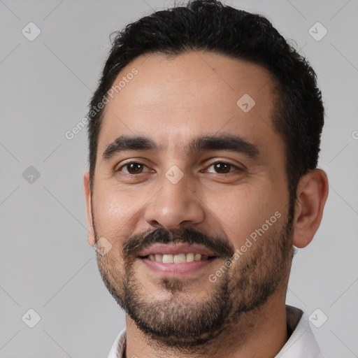 Joyful white young-adult male with short  black hair and brown eyes