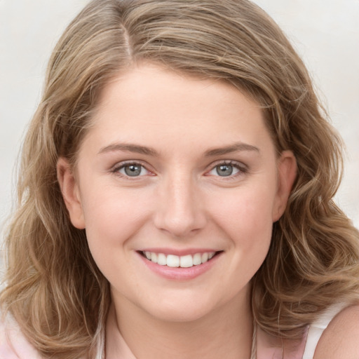 Joyful white young-adult female with long  brown hair and blue eyes