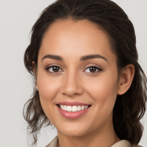 Joyful white young-adult female with long  brown hair and brown eyes