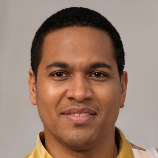 Joyful latino young-adult male with short  black hair and brown eyes