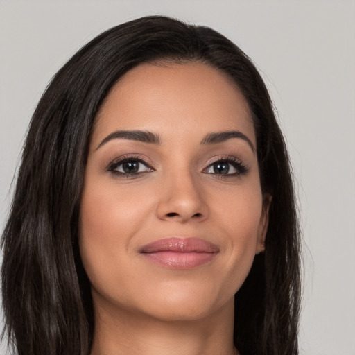 Joyful white young-adult female with long  brown hair and brown eyes