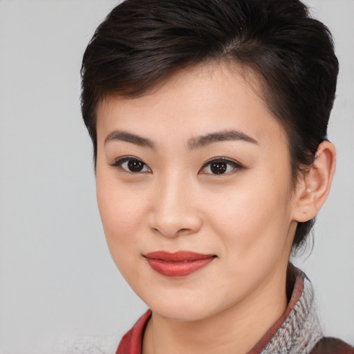 Joyful asian young-adult female with medium  brown hair and brown eyes