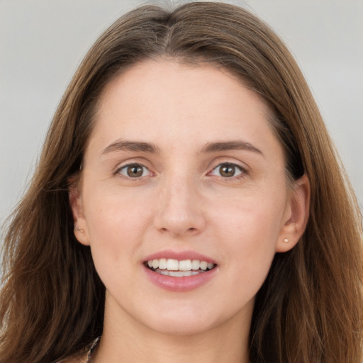 Joyful white young-adult female with long  brown hair and grey eyes