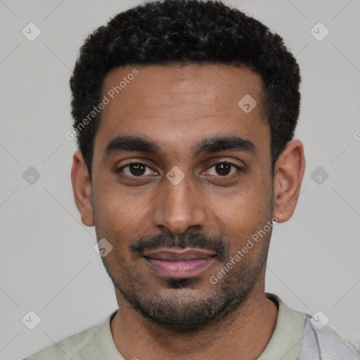 Joyful black young-adult male with short  black hair and brown eyes