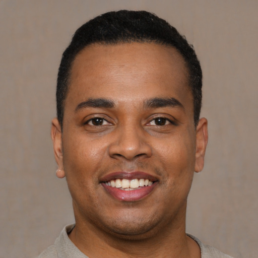 Joyful latino young-adult male with short  black hair and brown eyes