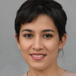 Joyful asian young-adult female with short  brown hair and brown eyes