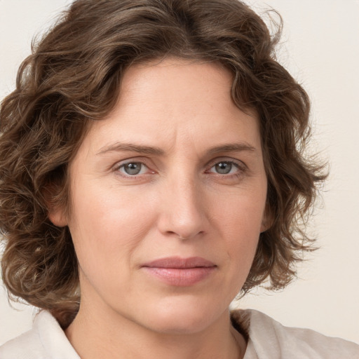 Joyful white young-adult female with medium  brown hair and green eyes