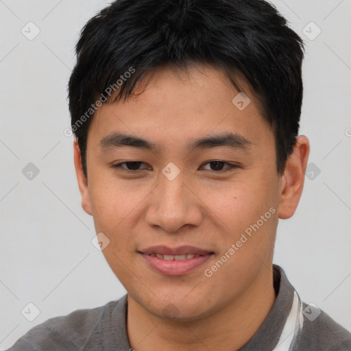 Joyful asian young-adult male with short  brown hair and brown eyes