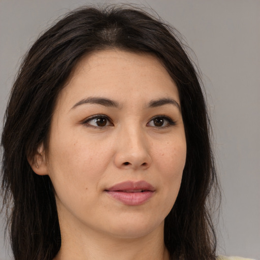 Joyful asian young-adult female with long  brown hair and brown eyes