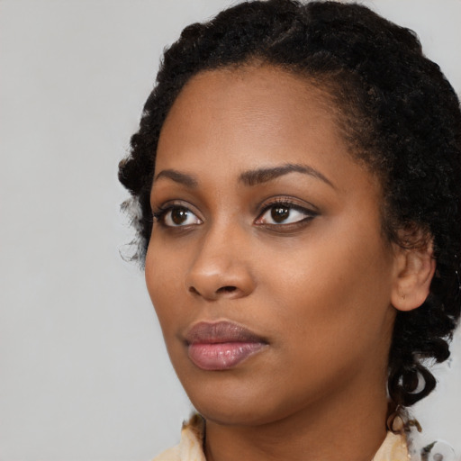 Neutral black young-adult female with medium  black hair and brown eyes