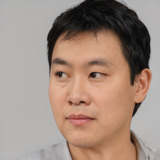 Neutral asian young-adult male with short  black hair and brown eyes