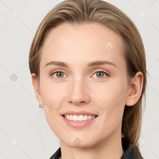 Joyful white young-adult female with medium  brown hair and grey eyes