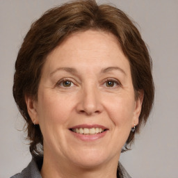 Joyful white adult female with medium  brown hair and grey eyes