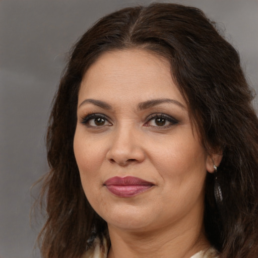 Joyful white adult female with long  brown hair and brown eyes