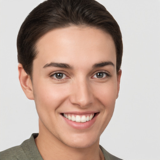 Joyful white young-adult female with short  brown hair and brown eyes