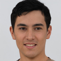 Joyful asian young-adult male with short  brown hair and brown eyes