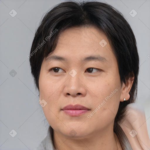 Joyful asian adult female with medium  brown hair and brown eyes