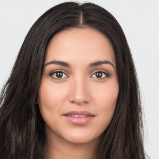 Joyful white young-adult female with long  brown hair and brown eyes