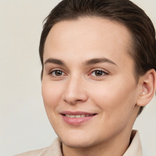 Joyful white young-adult female with short  brown hair and brown eyes