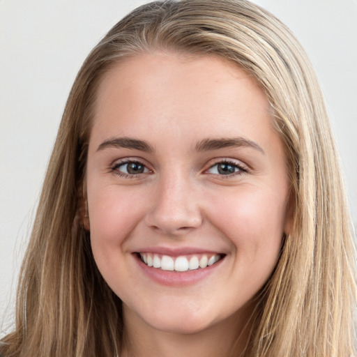 Joyful white young-adult female with long  brown hair and grey eyes