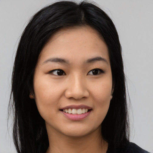 Joyful asian young-adult female with long  black hair and brown eyes