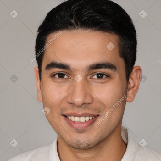 Joyful white young-adult male with short  black hair and brown eyes