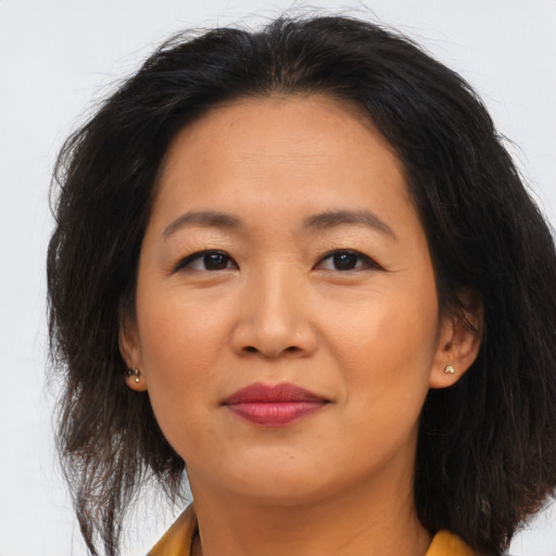 Joyful asian young-adult female with long  brown hair and brown eyes