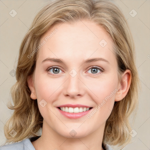 Joyful white young-adult female with medium  brown hair and blue eyes