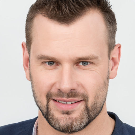 Joyful white adult male with short  brown hair and brown eyes