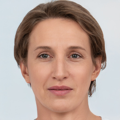 Joyful white adult female with medium  brown hair and grey eyes