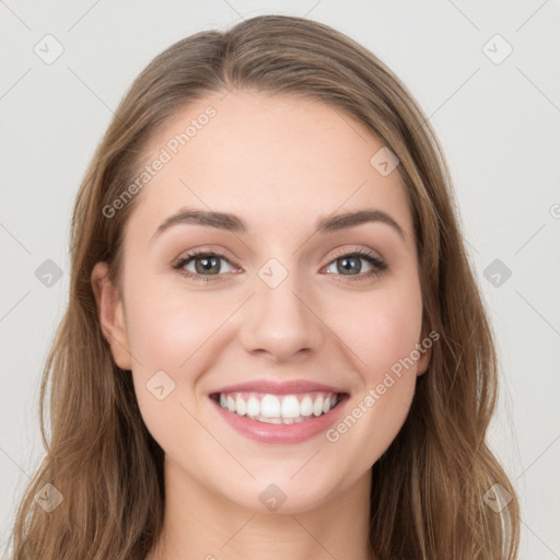 Joyful white young-adult female with long  brown hair and grey eyes