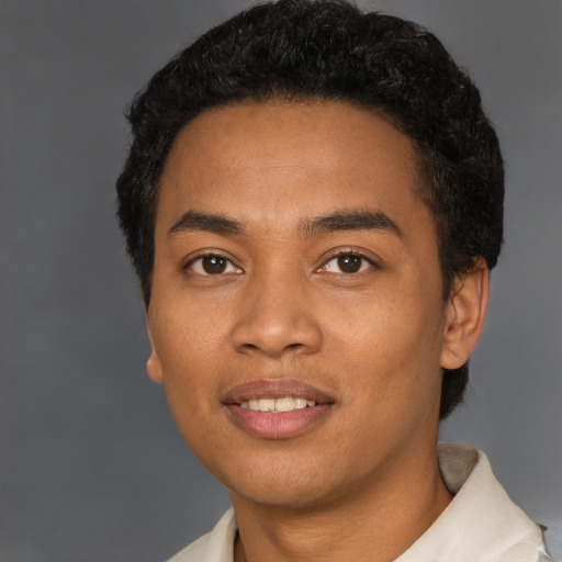 Joyful latino young-adult male with short  black hair and brown eyes