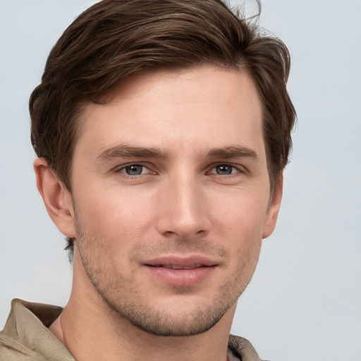 Joyful white young-adult male with short  brown hair and grey eyes