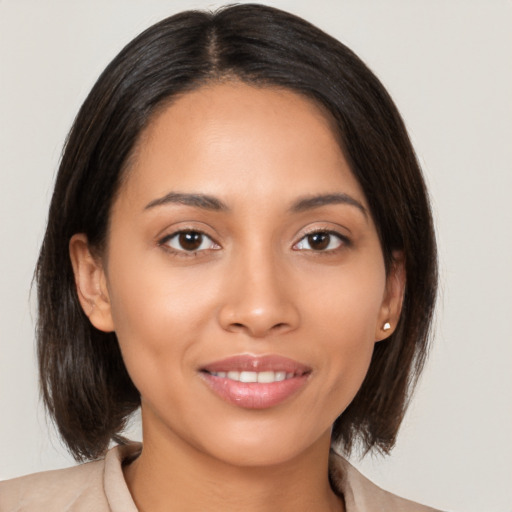 Joyful latino young-adult female with medium  brown hair and brown eyes