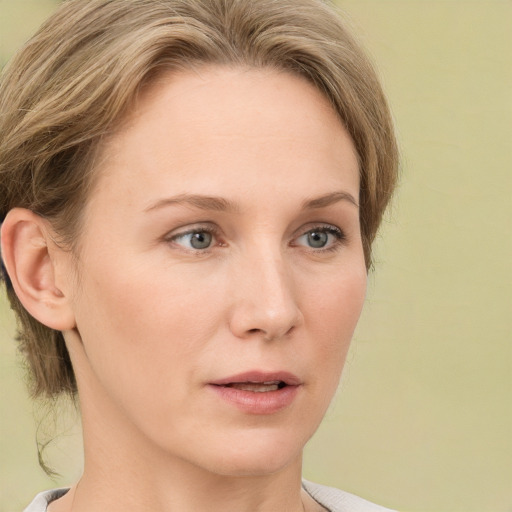 Joyful white young-adult female with medium  brown hair and green eyes