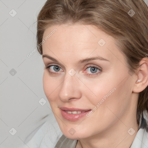 Joyful white young-adult female with medium  brown hair and blue eyes