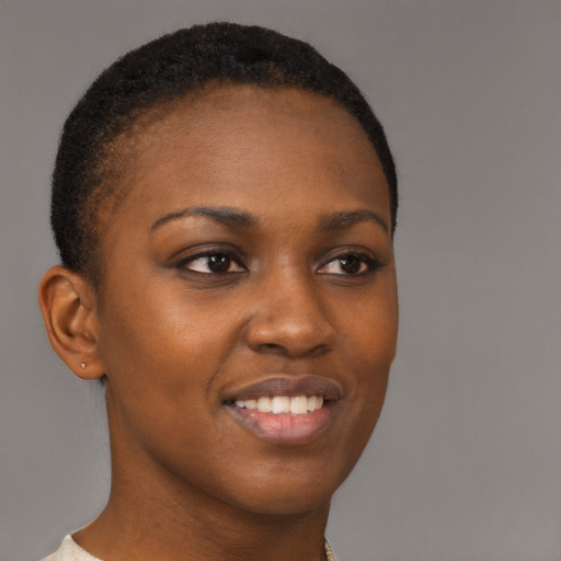 Joyful black young-adult female with short  brown hair and brown eyes